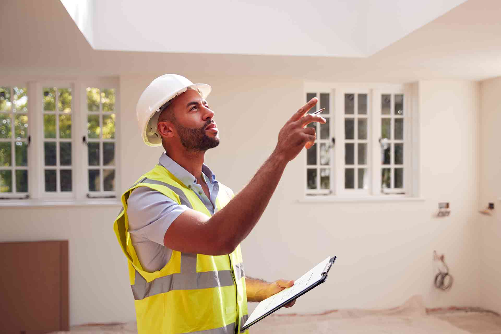 Third Party Wall Surveyors Camden reviewing plans between two parties during a dispute